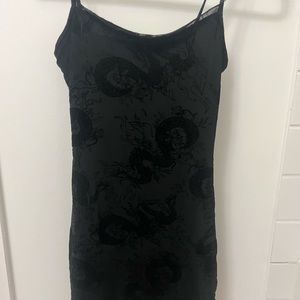 Black mini dress with dragon mesh details.